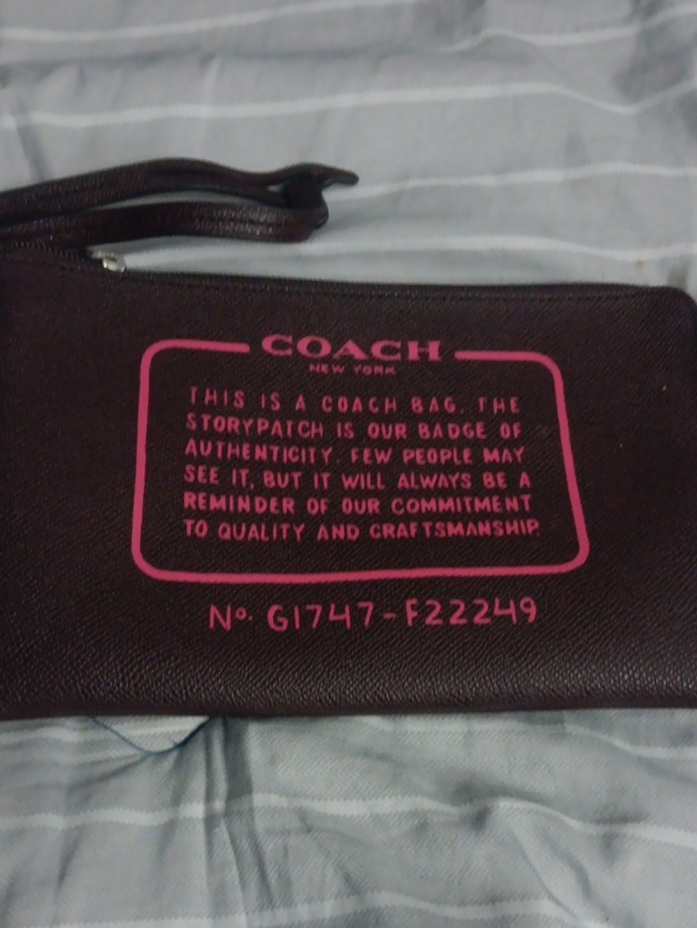 Coach Brown Wristlet with Pink Logo Print
